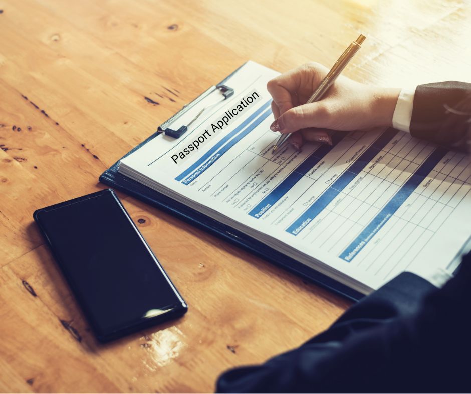 person filling-out passport application form